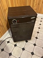 Overall front view of Samsung dehumidifier model 25 showing the control knob, indicator light, grille, and logo.