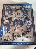Full view of the plaque showing multiple Toronto Maple Leafs jerseys and numerous signatures across the front.