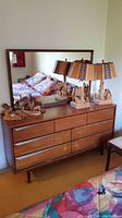 Full front view of dresser with mirror and decorative items on top