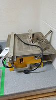 Full view of Work Force THD550 tile cutter on counter, showing cutting surface and handle.