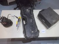 Full view of all items on white surface: Craftsman router case, submersible utility pump, Porter Cable reciprocating saw, unopened saw blades in packaging