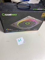 Closed retail box of Gamemax RGB power supply unit 850W showing branding and key features like 80 Plus Gold certification and RGB lighting.