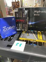 Overall view: Intel CPU box, Kingston Fury Beast DDR4 pack, Corsair Vengeance LPX kit and AMD Radeon RX 560 box visible