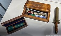 Overview of all items: two wooden boxes, brass telescope, diving knife and sheath