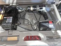 Photo showing Porter Cable 14.4V cordless drill and charger inside hard plastic carrying case