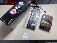 Overall shot showing unopened Corsair H150i Elite LCD cooler box and UtechSmart Venus gaming mouse box.