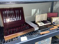 Three sets grouped: wooden handle carving set from Wm. A. Rogers, boxed Rogers Bros silverware set, nylon handled steak knives in a box