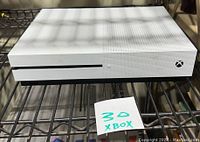 Front view of Xbox One S console showing disc drive slot and power button.