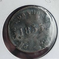 Front side of the token showing '1855' date and surrounding text 'P.E. ISLANDS R EDWARDS'.