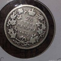 Close up of reverse side of the 1902 Canadian 25 cents silver coin showing crown, maple leaves, denomination, and date.