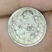 Reverse side showing denomination '5 Cents', country 'Canada', date 1919, crown and maple leaf wreath.
