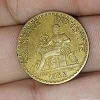 Obverse side of 1922 French 1 franc coin showing seated figure representing commerce and industry.