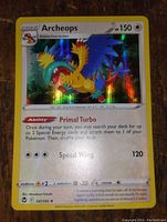 Close-up of Archeops holographic Pokémon card showing details and foil effect