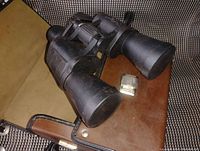 Close-up image of the Bushnell binoculars showing textured grips and lenses.