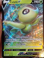 Close-up image of Celebi V holo foil full art Pokémon card showing front design, artwork, text, and foil pattern.