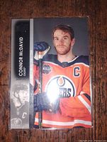 Connor McDavid hockey card front featuring player portrait, team logo, and name panel