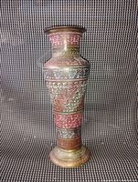 Front and full view of colorful hand-etched brass vase with ornamental floral design