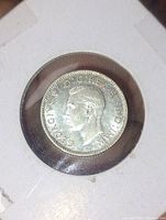 Obverse side of the 1947 Canadian 10 cent silver coin showing King George VI profile and inscriptions