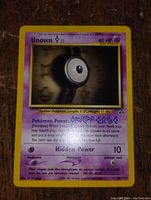 Unown Q Pokémon card image showing front side of the card with purple border and 40 HP.