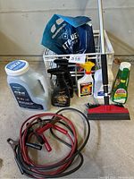 Photo showing entire lot with booster cables, car cleaners, ice scraper/squeegee tool, car brush, and cleaning liquids.