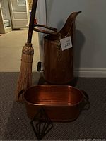 Full view of umbrella stand, planter, and broom for scale