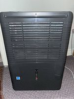 Front view of the black Danby Premiere dehumidifier showing the grille and water level window.