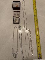 Full overview of the jewelry set showing all items including necklaces, bracelets, earrings, and brooches.