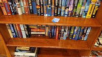 Bookshelves filled with mostly Clive Cussler books with various titles visible.