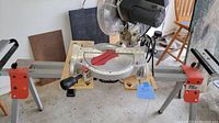 Mitre saw setup showing blade, angle gauge and motor.