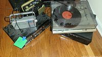 Overall lot with Technic turntable, stereo equipment, and radio on the floor.