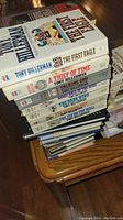 Stack of Tony Hillerman books on a wooden surface showing titles and condition