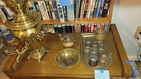 Full view of samovar and accompanying brass bowl, teapot, tray with glass holders and spoons