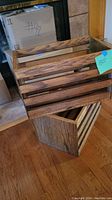 Two wooden totes stacked, showing slatted sides and solid wood end panels.