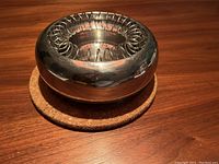 Top view of ALESSI Spirale ashtray showing spiral coil design and polished stainless steel finish.