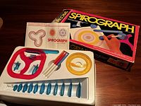 Complete Spirograph set showing included components and booklet within the box interior.