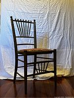 Full side view of vintage faux bamboo gilded chair with upholstered seat showing structure and design