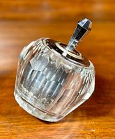 Side angled view of the 1960s vintage Korex style electro match lighter made of faceted cut lead crystal with attached ignition wand and metal lid.