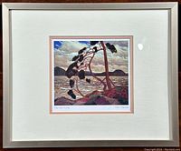 Framed print showing full view of 'The West Wind' by Tom Thomson with cream mat and silver frame.