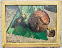 Full image of the oil painting showing the still life subject with copper vessel, green cloth, and candlestick, framed in a light wooden frame.