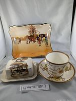 Set of three antique porcelain items: Royal Doulton decorative plate, Lancaster & Sand Land butter dish, and an antique mug