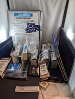 Photo showing assorted coin trays and storage boxes, primarily Leuchtturm Münz-Tableaus and Quadrum with quantity labels.