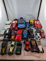 Overview of 20 diecast collectible vehicles arranged on white background