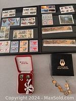 Photo showing multiple pages of postage stamps in black album sleeves with various designs and colors.