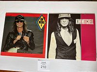 Front covers of two Kim Mitchell albums side by side on a white surface.