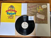Photo shows the Cheech & Chong vinyl album with bright yellow cover featuring colorful lettering and graphics, along with the black vinyl record and inner sleeve.