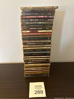 Stack of approximately 30 1990s music CDs including clearly visible titles Pearl Jam Vitalogy, Creed Human Clay, Soundgarden Superunknown, among others.