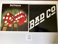 Front covers of the two Bad Company vinyl albums: "Straight Shooter" with dice artwork and black cover with 'Bad Co' logo on the other.