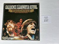 Front cover of Creedence Clearwater Revival album featuring photo of band members and album title.