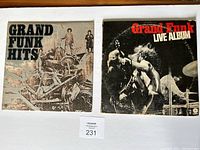 Front covers of the two Grand Funk Railroad albums: 'Grand Funk Hits' and 'Grand Funk Live Album'.