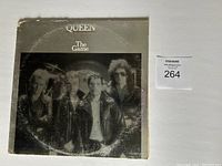 Front cover of Queen The Game album showing the band members and album title.